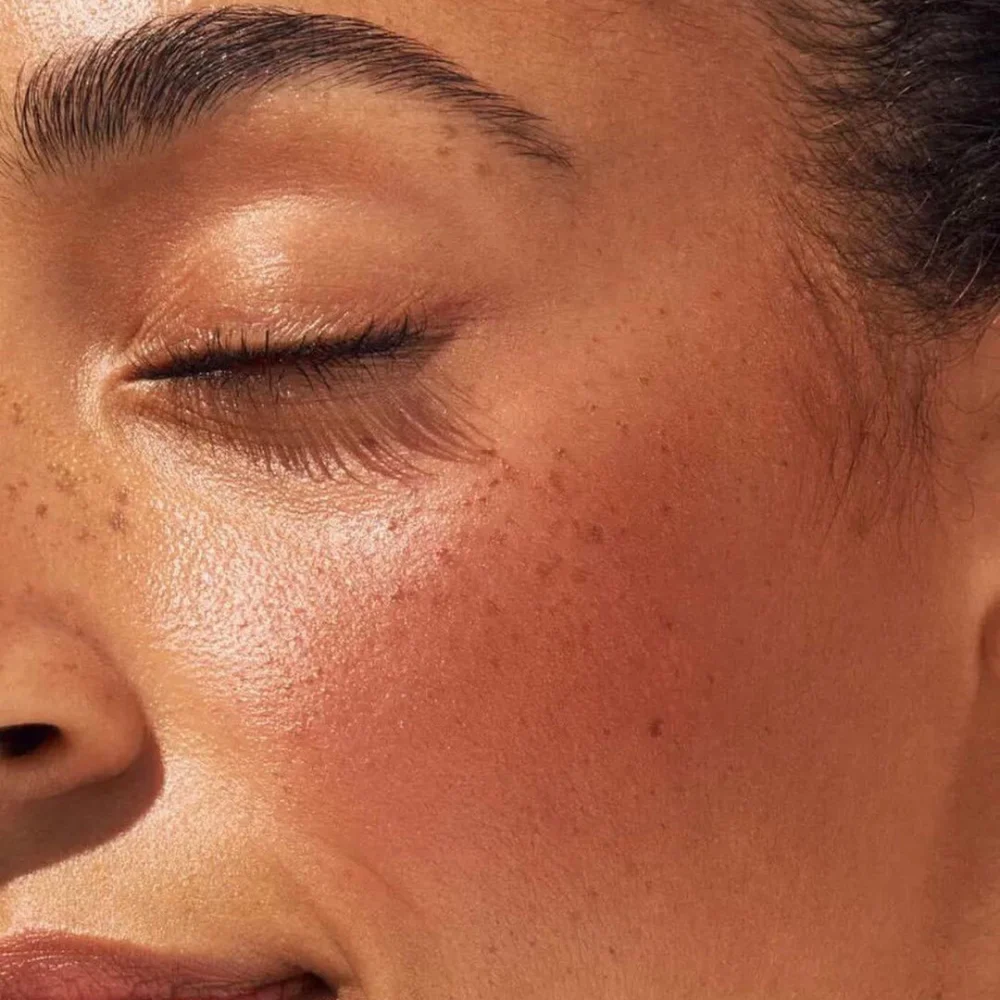 Close-up of a person's face with closed eyes.