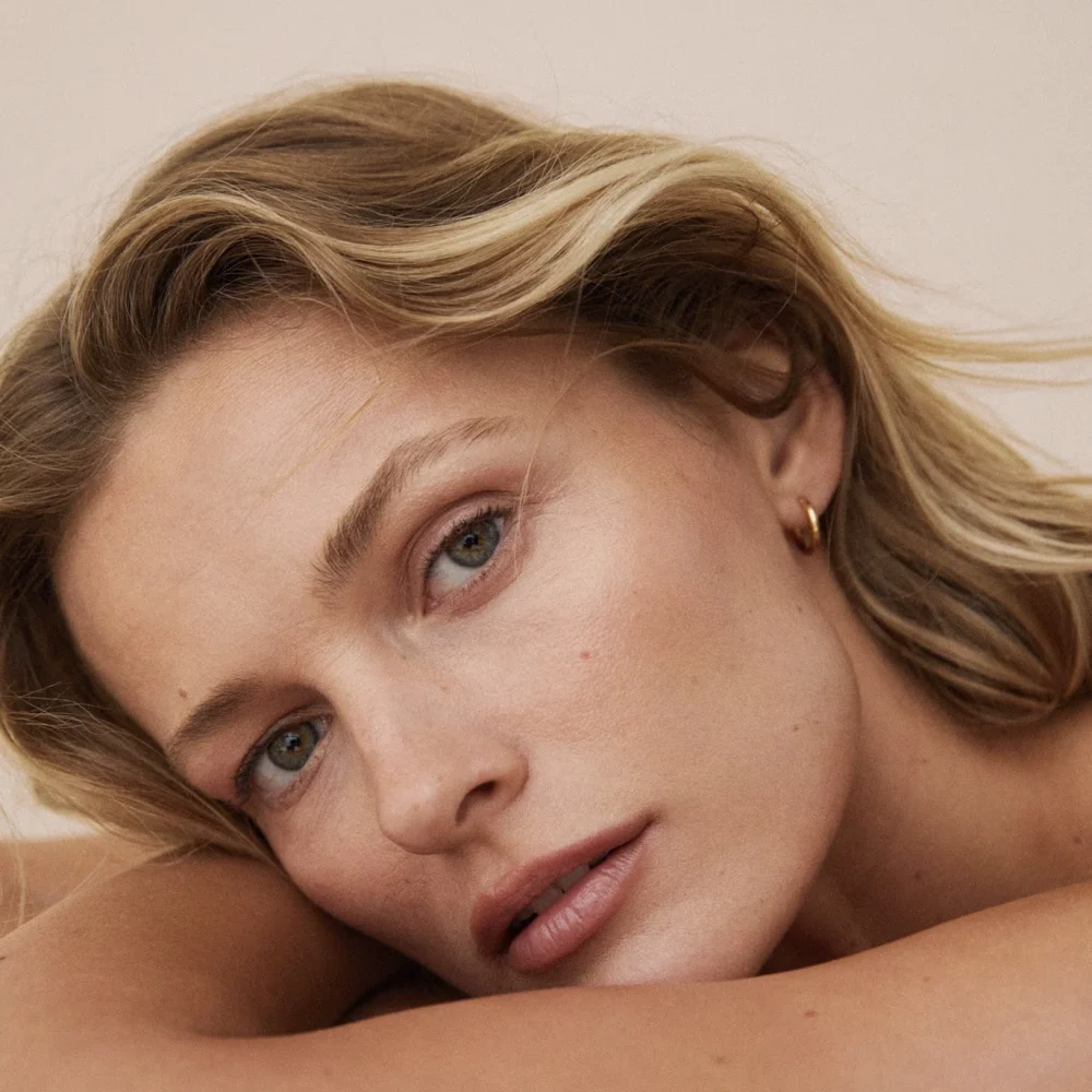 Person with blond hair and resting head.